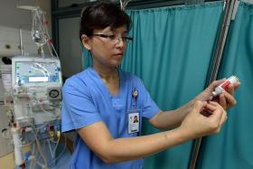 PROCEDURE: Ms Ooi Swee Ling, an assistant nurse clinician at TTSH, demonstrating the safe way of extracting injectable medication from a multi-dose vial