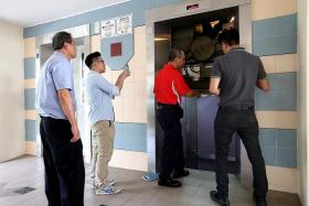 CHECKS:  Lift repairmen inspecting lift B at Block 322, Tah Ching Road at 2pm on Friday afternoon.