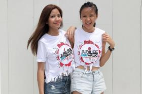 NEW FACE GIRLS: Amy Syireen Marican, 18, and Lee Qian Hui, 23, (left to right) showing off their altered Jubilee Big Walk shirts.  