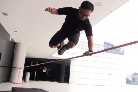TRICKS: Mr Heng Yongli performing tricklining, which involves stunts such as bouncing, somersaults and backflips.