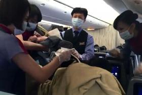 TEAMWORK: Flight crew working on board the China Airlines plane to help deliver the baby girl. 