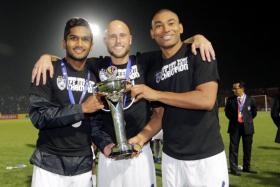 Johor Darul Takzim (JDT) players (from left) Hariss Harun, Luciano Figueroa and Marcos Antonio lifting the AFC Cup. 