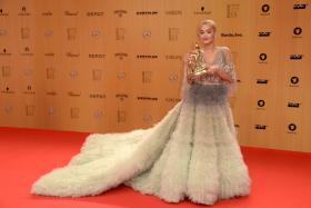 Rita Ora poses for photographers with her award at the Bambi awards on November 12, 2015 in Berlin.