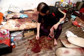 SO MUCH BLOOD: Madam Teo Ah Whah showing the blood-soaked mattress in the master bedroom.