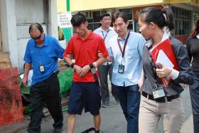 Chinese national Li Yongxiang was brought to the scene of a brutal slashing in a Kranji Loop factory on June 24, 2013. 