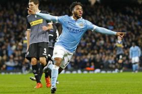 Raheem Sterling celebrates after scoring the third goal for Manchester City.
