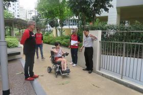 MOVING GIFT: (From left) ONE FM DJs The Flying Dutchman, Glenn Ong and Andre Hoeden, who presented the motorised wheelchair to Alicia, along with Rehab Mart&#039;s operations manager Edward Bu.
