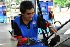 JOB: Mr Tan Soy Kiang working at a Esso petrol station in Toa Payoh.