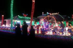 Visitors view the massive light display set up in the home of Mark and Kathy Hyatt in Plantation, Florida.