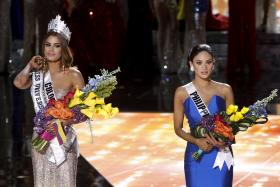 SHAME: Miss Colombia, Ariadna Gutierrez (left) with her crown beside Miss Philippines before the host announced his mistake. 