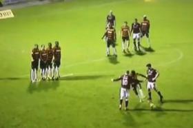 Barnet defender Gavin Hoyte attempts to prevent Northampton from executing their free-kick routine.