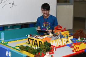A-MAZE-ING: NYP student Wu Jia Jie navigating a droid out of the Lego maze using an iPad.