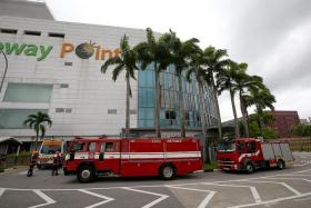 AT THE SCENE: The Singapore Civil Defence Force was alerted to the fire at the Bagus foodcourt at Causeway Point yesterday morning.