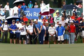 CROWD-PULLER: All eyes are on Jordan Spieth (holding club) on the first day of the SMBC Singapore Open.