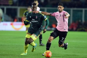 AC Milan striker Mario Balotelli (left) vies for a ball with a Palermo defender in a Serie A match in his hometown of Palermo on Feb 3. 