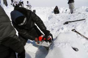 DEADLY: A rescuer cutting through ice during the search for survivors after a deadly avalanche on the Siachen glacier in Kashmir. 