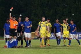 OVERSEAS VENTURE: Harimau Muda (in blue) participated in the S.League until last year, concluding the Football Association of Malaysia's four-year agreement to have a youth side compete here.