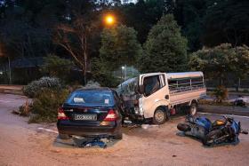 AFTERMATH: Mr Mark Lim&#039;s black Mercedes Benz, the lorry and a motorcycle that was later found to also be involved in the accident. 