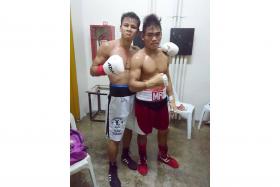 THERE&#039;S ALWAYS A FIRST TIME: Singapore boxer Ridhwan Ahmad (in white trunks) posing with his beaten opponent, Melchor Roda, who suffered his first pro career defeat. 