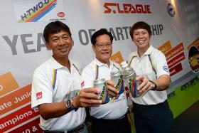 ALL SMILES: (From far left) S.League CEO Lim Chin, FAS vice-president Lim Kia Tong and Yeo Hiap Seng (Singapore) 1st vice-president May Ngiam raising a toast for youth football yesterday.
