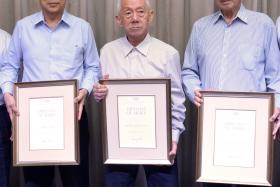 AWARD RECIPIENTS: From near right, Chris Chan, Tan Howe Liang and Tan Eng Liang are honoured for their contributions to the Olympic movement. 