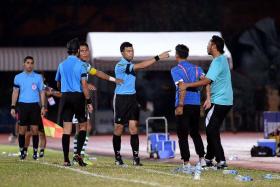 1) YOU&#039;RE OFF:  Geylang coach Hasrin Jailani (left, with red lanyard) being restrained by team manager Aizat Ramli, after being sent to the stands by referee Sukhbir Singh (far left), who is talking to Geylang captain Isa Halim.