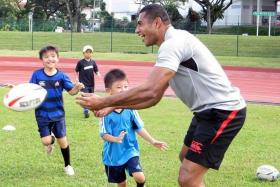 FUN TIME: Sunwolves player John Stewart conducting a rugby clinic for some 50 children from the local Japanese community yesterday.  