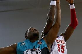 BATTLE OF THE BIG MEN: Reginald Johnson (left) stars for the Westports Malaysia Dragons while Justin Howard (right) has a night to forget for the Singapore Slingers.  