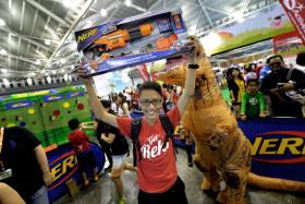 JOY: (Above) Linn Min Htoo, defending champion of the Nerf Maze Competition, with the Nerf blaster he won.
