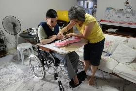 GIVING CARE: Madam Lei Shuyan with her son, Mr Li Xingjing.