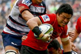 STRUGGLE: Sunwolves’ Harumichi Tatekawa (in red) trying to break through the Rebels’ defence during their match in Tokyo last Sunday. 
