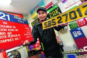 TREASURES: Mr Muhammad Zakaria Azmi has collected more than 500 pieces of bus-related items, but his most precious is a SBS2701Z bus number plate (above).