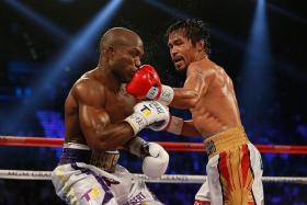 LEFT IS RIGHT: Manny Pacquiao landing a left hook on Tim Bradley en  route to his  win yesterday.