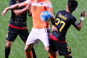 GOAL DROUGHT: Balestier striker Miroslav Kristic (No. 11) extended his barren run to 877 minutes, after drawing blanks against Kaya FC (in black) in their AFC Cup match last night. 