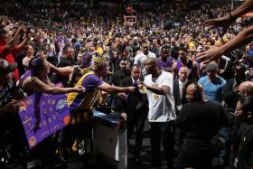 SUPPORT: A bigger turnout is expected as fans bid farewell to Kobe Bryant (centre) in his final game this morning. 