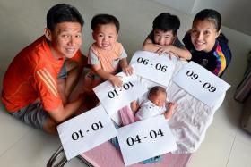 DOUBLE HAPPINESS: Mr Sharmen Loke and his wife, Madam Yau Mei Siong, with their children, Lucius, Andrius and Justinius.