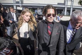 SMUGGLE: (From left) The &quot;war on terrier&quot; started when US actress Amber Heard was discovered to have brought two dogs to Australia without declaring them. She was visiting husband, US actor Johnny Depp, who was filming the latest Pirates Of The Caribbean movie.