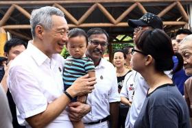 ALL SMILES: PM Lee Hsien Loong and PAP candidate for Bukit Batok by-election Murali Pillai greeting people around the estate during a walkabout