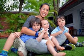 ALL SMILES: Joscelin Yeo with her sons (from left) David, Michael and Sean.   