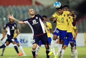 SHOCK DEFEAT: Billy Mehmet (No. 25) and his Tampines teammates lost 3-2 to Sheikh Jamal Dhanmondi (in yellow) in their last AFC Cup match.