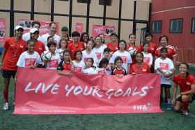 GIRL POWER: Participants (left) at the first Fifa &quot;Live Your Goals&quot; Festival in Singapore held at Queensway Secondary School yesterday.