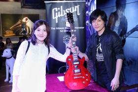 FAN: Monster with superfan Cynthia Zhu, who flew from New York City to Hong Kong to have her Epiphone Mayday Monster Les Paul electric guitar signed by the guitarist himself. 