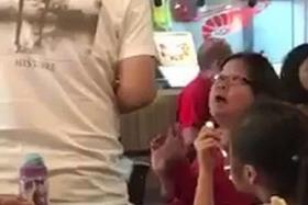 SNAP: In a video posted online, Ms Alice Fong (right, in red) launched into a tirade after a deaf cleaner tried to clear her food. The cleaning company&#039;s operations manager Steve (left, in white) tried to explain that the cleaner is deaf.