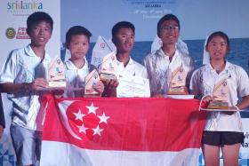 PROUD DAY: The Singapore team comprising (from far left) Daniel Ian Toh, Daniel Hung, Muhammad Daniel, Raynn Kwok and Jodie Lai finished second, while Muhammad was first in the individual category in Sri Lanka.   