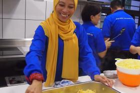 HAPPY: Ms Juzailah Abdul Rahin cooking for the needy.