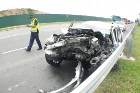 MANGLED: The damaged front part of the car after the accident along Changi Coast Road. 