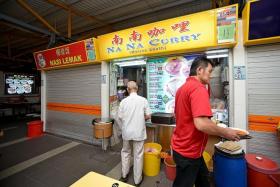 CAUGHT OFF GUARD: Hawkers such as Madam Poh Swee Lan from Na Na Curry  (above) said they had no idea a Michelin Guide inspector had visited their stalls, less so pegged them for awards.