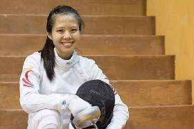 MIND OVER BODY: Playing through pain, Victoria Ann Lim (above) claimed bronze in the women&#039;s individual epee on Thursday.