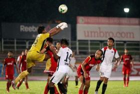 OUCH: Balestier goalkeeper Naqiuddin Nodin (in yellow) colliding with teammate Fadli Kamis while punching away a corner kick. TNP