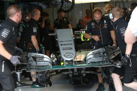 REPAIRS:  The Mercedes engineers have to work on Lewis Hamilton&#039;s car (above) after the Briton&#039;s crash.